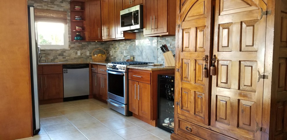 This is an example of a small country u-shaped eat-in kitchen in San Francisco with an undermount sink, shaker cabinets, medium wood cabinets, granite benchtops, grey splashback, stone tile splashback, stainless steel appliances, ceramic floors, beige floor and beige benchtop.
