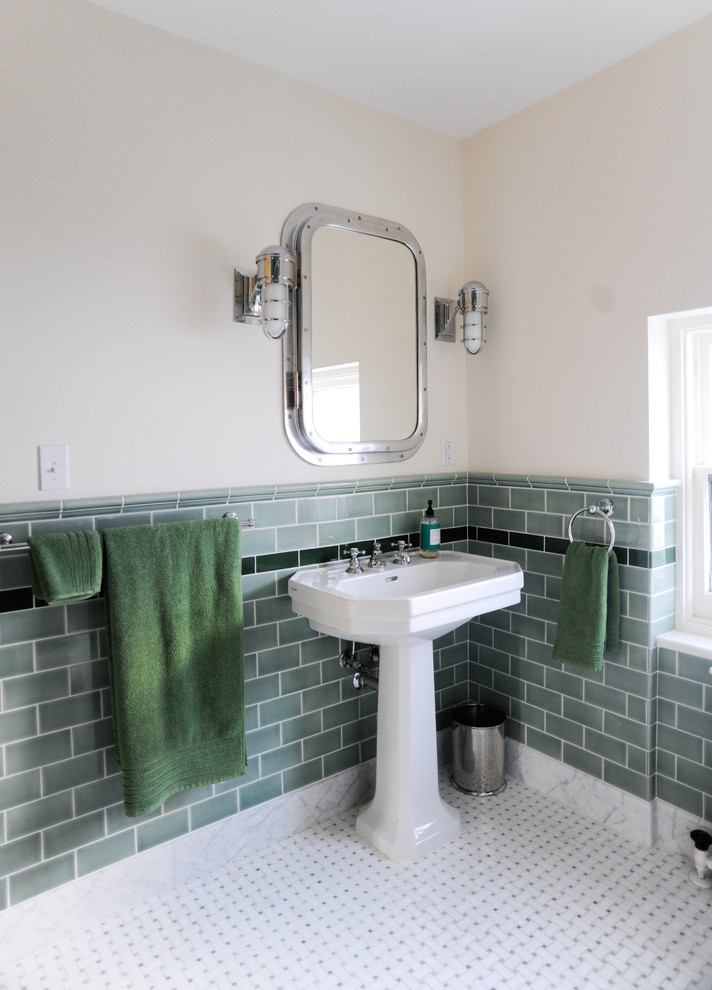 This is an example of a traditional bathroom in New York with a pedestal sink, green tile, subway tile and beige walls.