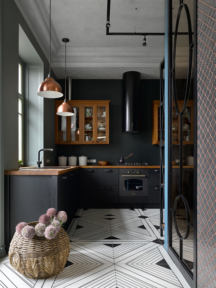 Design ideas for a contemporary l-shaped separate kitchen in Moscow with a drop-in sink, flat-panel cabinets, black cabinets, wood benchtops, black splashback, black appliances, no island, multi-coloured floor and brown benchtop.