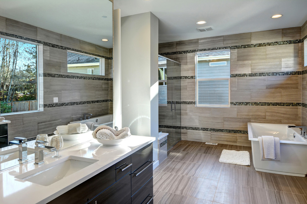 This is an example of a modern master bathroom in Seattle with flat-panel cabinets, dark wood cabinets, a freestanding tub, a curbless shower, gray tile, ceramic tile, grey walls, ceramic floors, an undermount sink and engineered quartz benchtops.