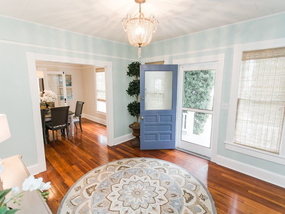 Photo of a mid-sized beach style foyer in Jacksonville with blue walls, medium hardwood floors, a dutch front door and a blue front door.