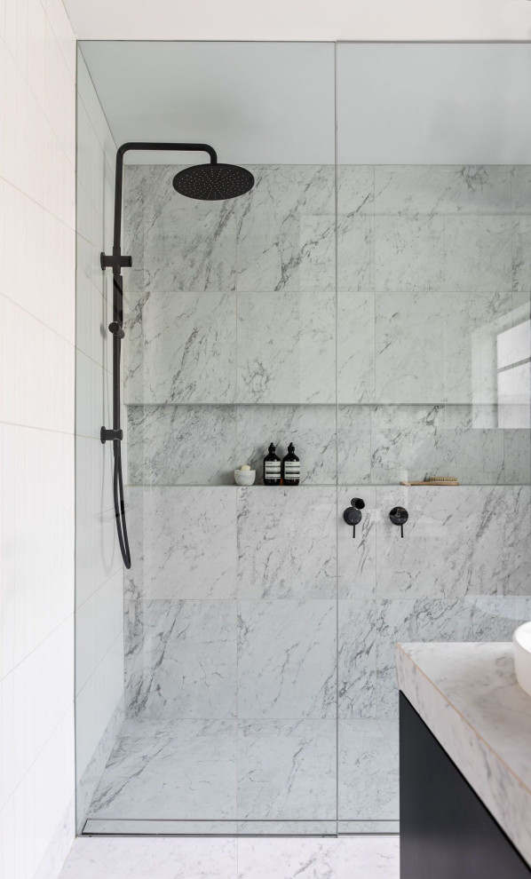 This is an example of an industrial bathroom in Sydney with black cabinets, a double shower, white tile, marble floors, tile benchtops, a niche, a single vanity and porcelain tile.