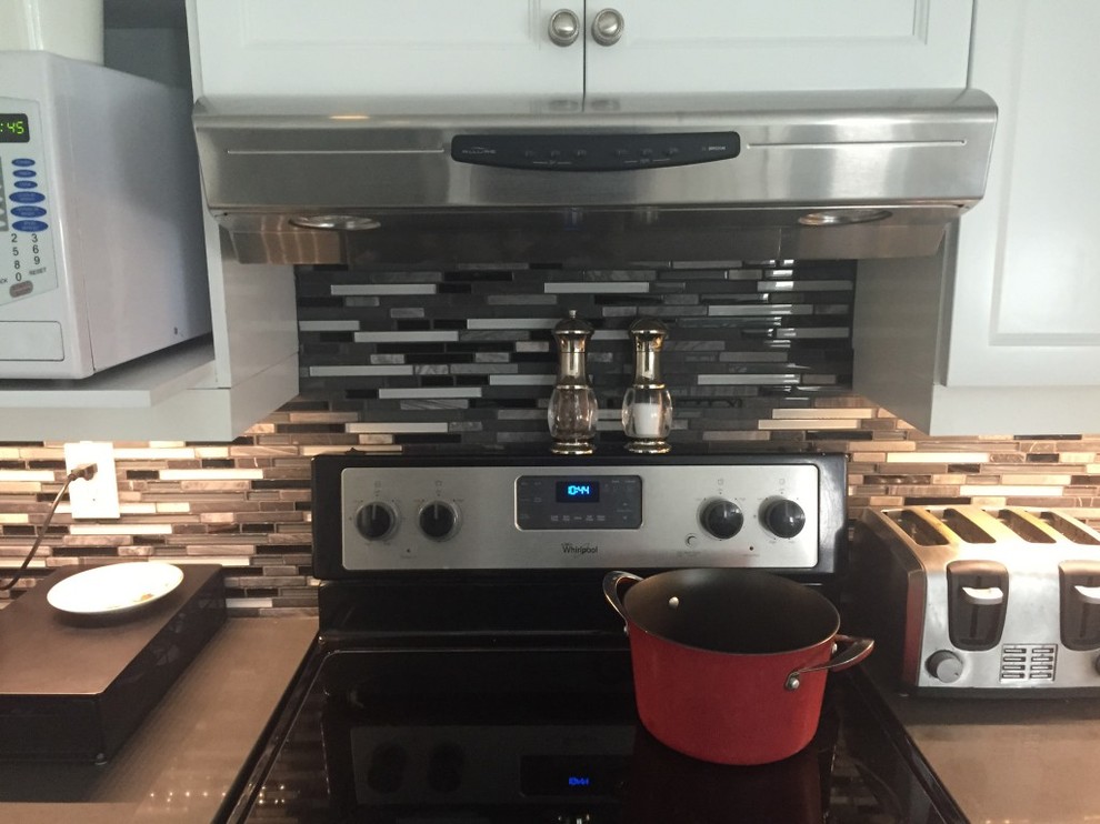 Inspiration for a mid-sized transitional kitchen remodel in Ottawa with raised-panel cabinets, white cabinets, matchstick tile backsplash, stainless steel appliances, quartzite countertops and multicolored backsplash