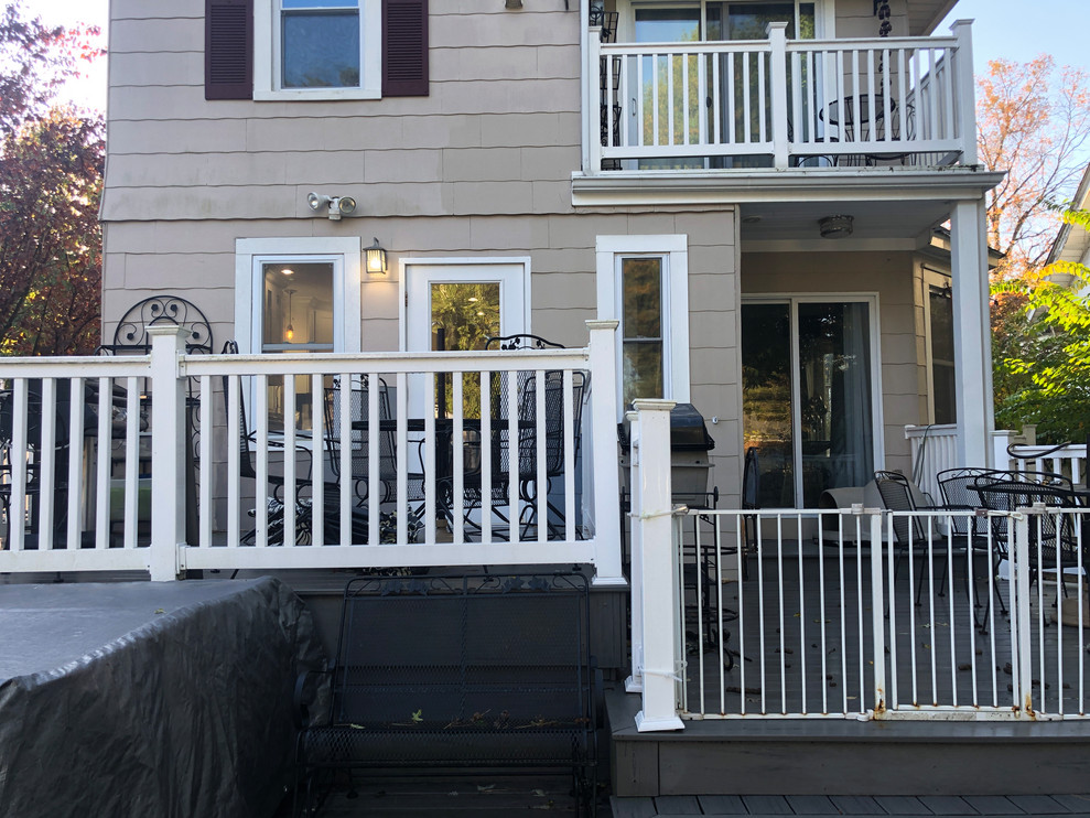 Example of a mid-sized classic backyard deck design in Newark with no cover