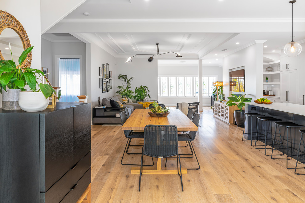 Photo of a mid-sized contemporary dining room in Brisbane with light hardwood floors.