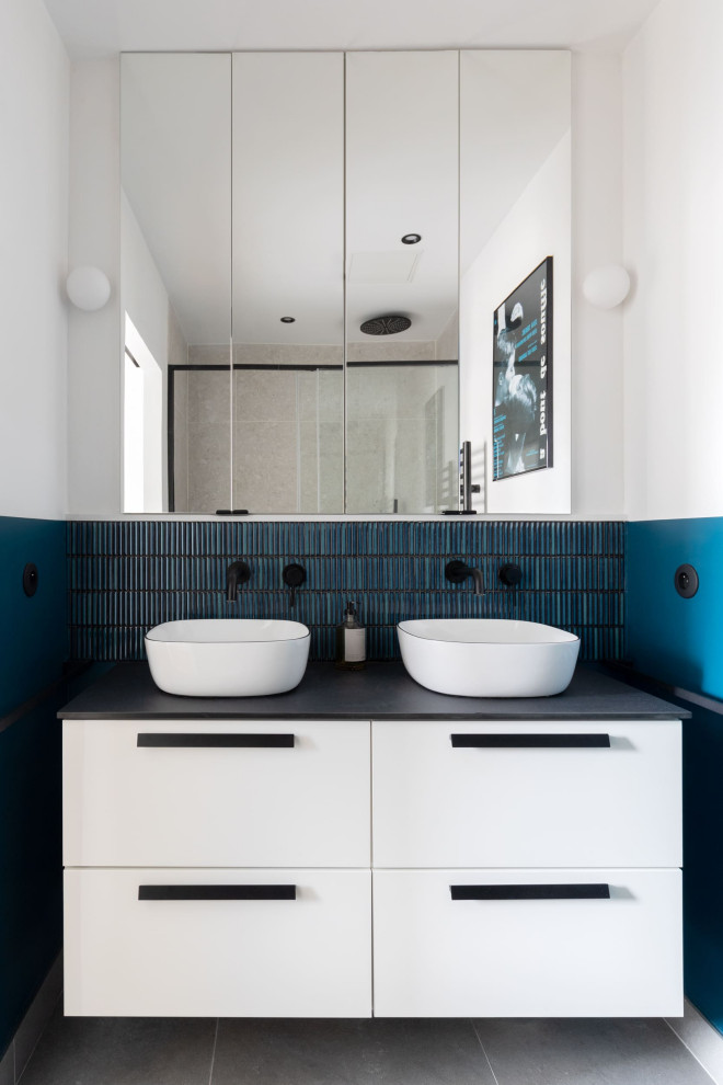 Design ideas for a mid-sized scandinavian master bathroom in Paris with white cabinets, a curbless shower, blue tile, mosaic tile, white walls, a drop-in sink, concrete benchtops, grey floor, a hinged shower door, black benchtops, a double vanity, a built-in vanity and flat-panel cabinets.