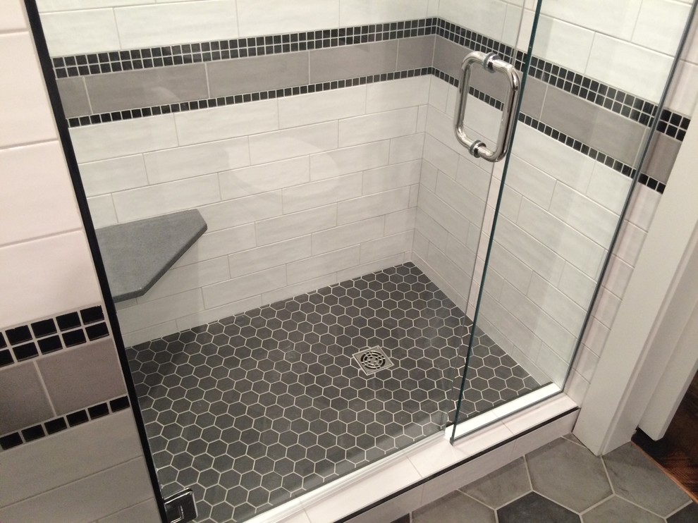 Small transitional master white tile and cement tile porcelain tile alcove shower photo with shaker cabinets, dark wood cabinets, black walls, an undermount sink and granite countertops