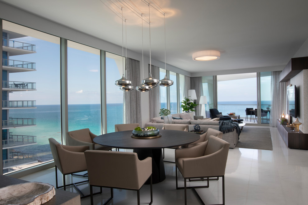Photo of a contemporary dining room in Miami with grey walls and white floor.