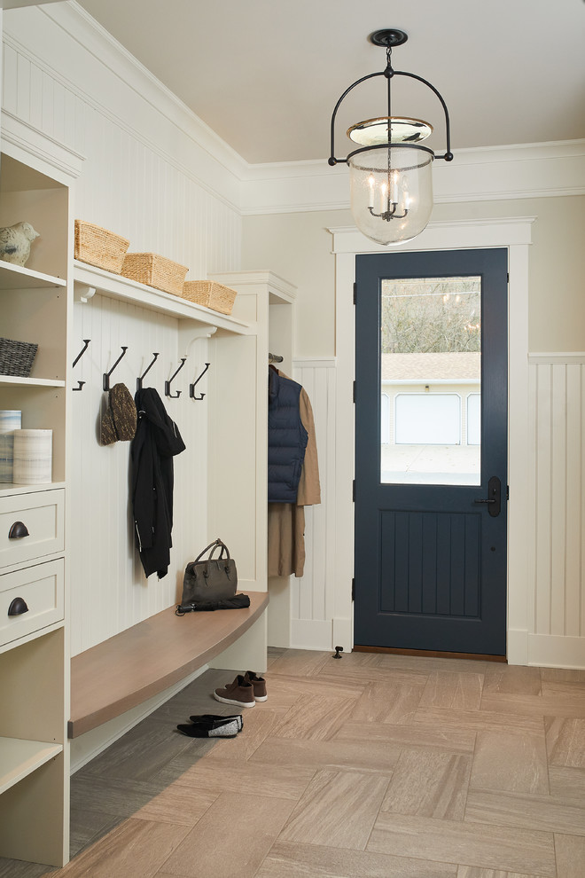 Design ideas for a mid-sized transitional mudroom in Detroit with beige walls, a single front door, a blue front door, brown floor and porcelain floors.
