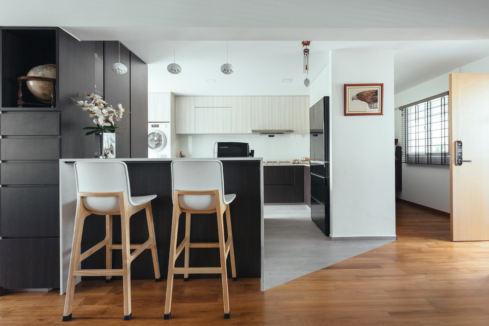 Inspiration for an asian u-shaped separate kitchen in Singapore with flat-panel cabinets, white cabinets, white splashback, black appliances, a peninsula, grey floor and white benchtop.