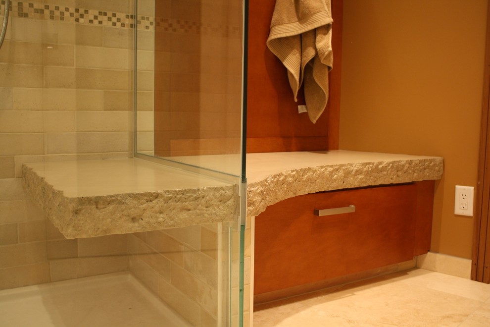 This is an example of a mid-sized transitional bathroom in Other with a vessel sink, furniture-like cabinets, medium wood cabinets, wood benchtops, a curbless shower, beige tile, stone tile, beige walls and porcelain floors.