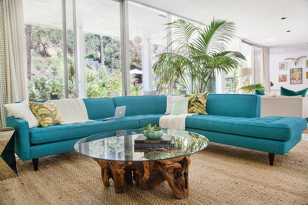 Photo of a midcentury open concept living room in Los Angeles with white walls.