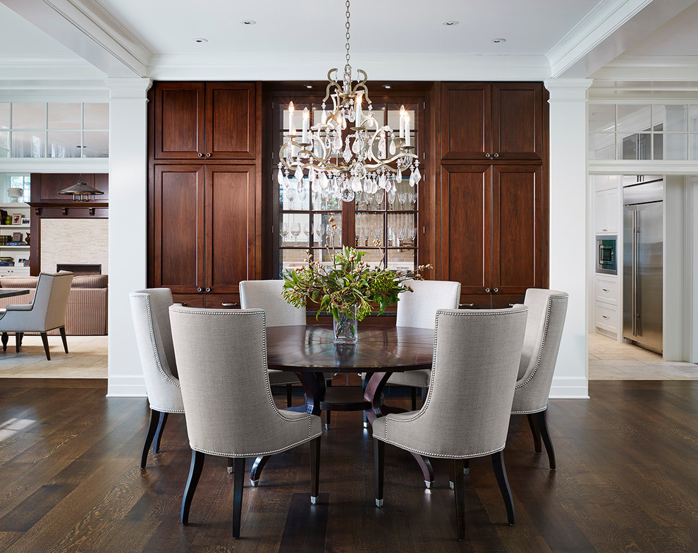 Large traditional dining room in Chicago with white walls, dark hardwood floors and no fireplace.