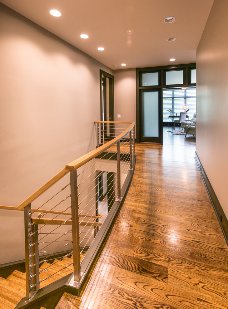 Inspiration for a large transitional wooden u-shaped open staircase remodel