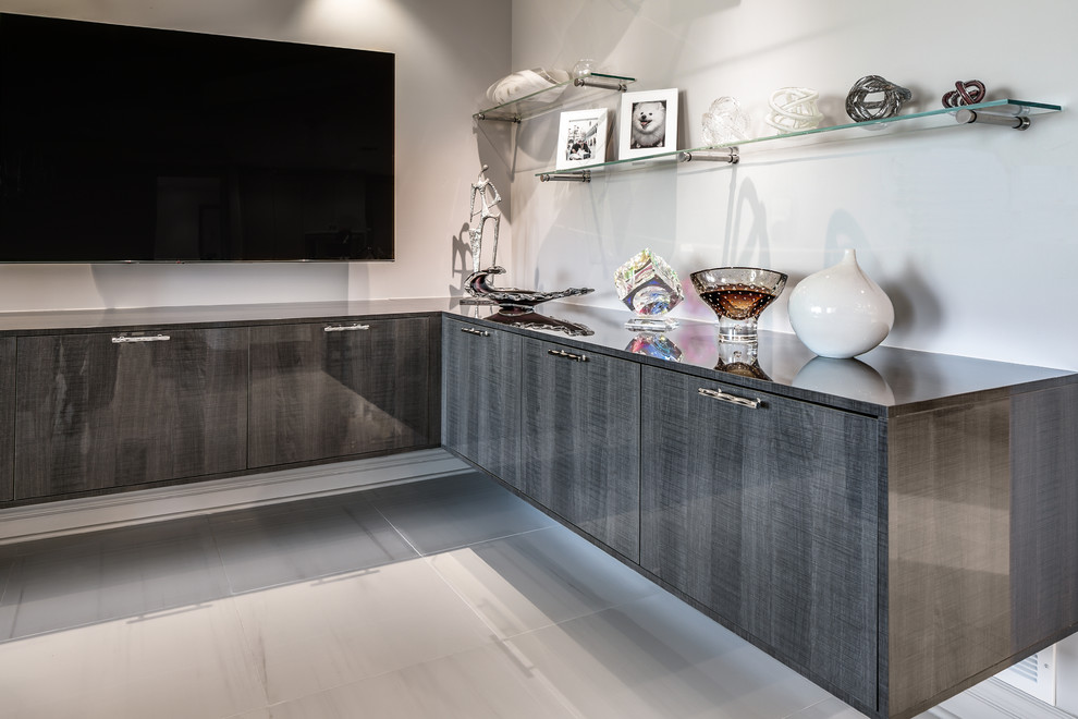 This is an example of a mid-sized modern l-shaped home bar in Phoenix with flat-panel cabinets, grey cabinets, laminate benchtops, white floor and grey benchtop.