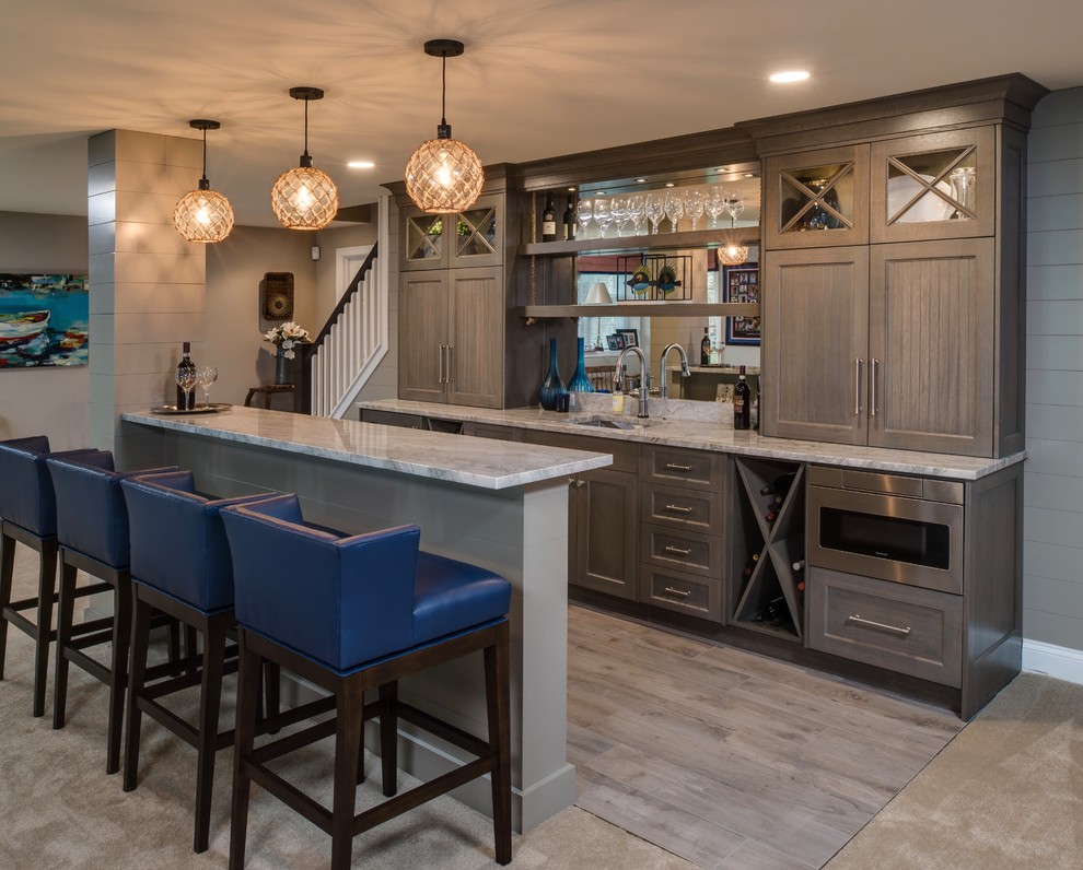 Inspiration for a mid-sized beach style home bar in Detroit with carpet and beige floor.