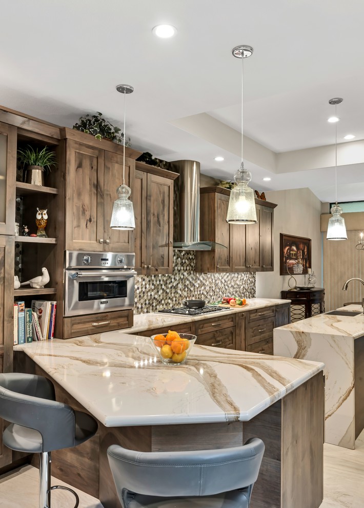 Design ideas for a large contemporary galley eat-in kitchen in Los Angeles with a farmhouse sink, flat-panel cabinets, medium wood cabinets, quartzite benchtops, metallic splashback, mosaic tile splashback, stainless steel appliances, porcelain floors, with island, beige floor and beige benchtop.