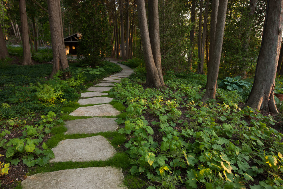 Design ideas for a large rustic partial sun side yard stone landscaping for summer.