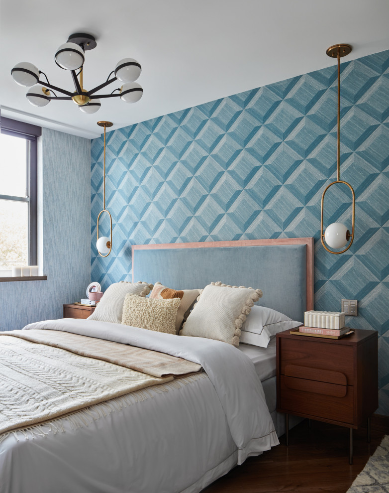 This is an example of a medium sized retro guest bedroom in London with blue walls, medium hardwood flooring, brown floors, wallpapered walls and a feature wall.