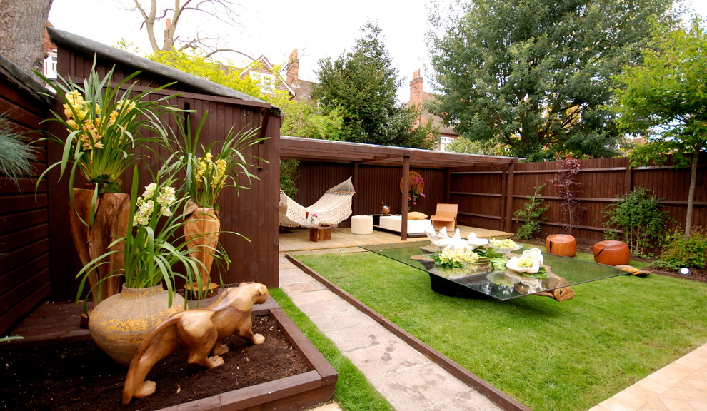 This is an example of a mid-sized asian backyard garden in London with a container garden.