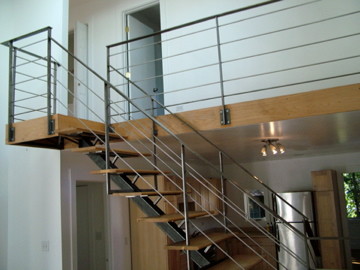 Mid-sized contemporary wood l-shaped staircase in San Francisco with wood risers and metal railing.
