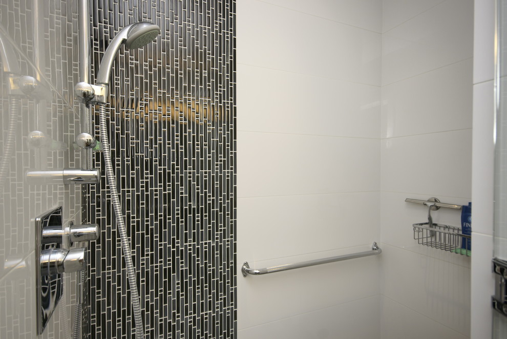 Inspiration for a large contemporary master bathroom in Vancouver with an alcove shower, gray tile, flat-panel cabinets, medium wood cabinets, a two-piece toilet, porcelain tile, white walls, ceramic floors, an undermount sink, quartzite benchtops, a hinged shower door and white benchtops.