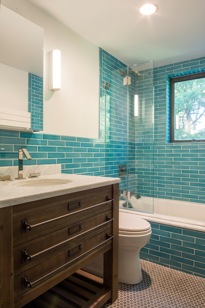 This is an example of a mid-sized modern master bathroom in New York with furniture-like cabinets, medium wood cabinets, a drop-in tub, an open shower, blue tile, white walls, an undermount sink, an open shower, white benchtops, brown floor, a single vanity and a freestanding vanity.