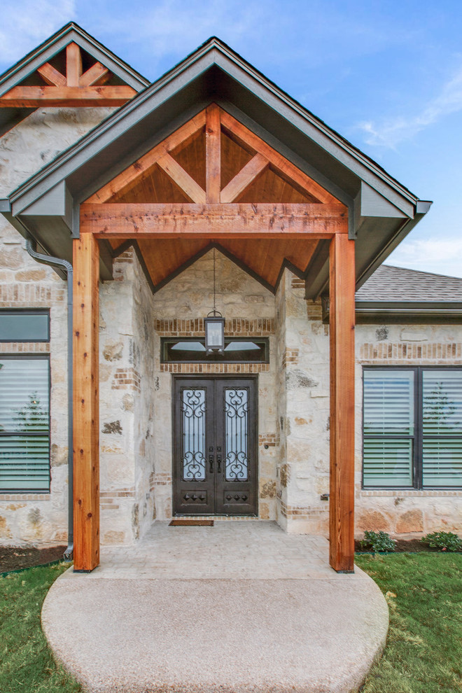 Country front door in Austin with beige walls, a double front door, a brown front door and beige floor.