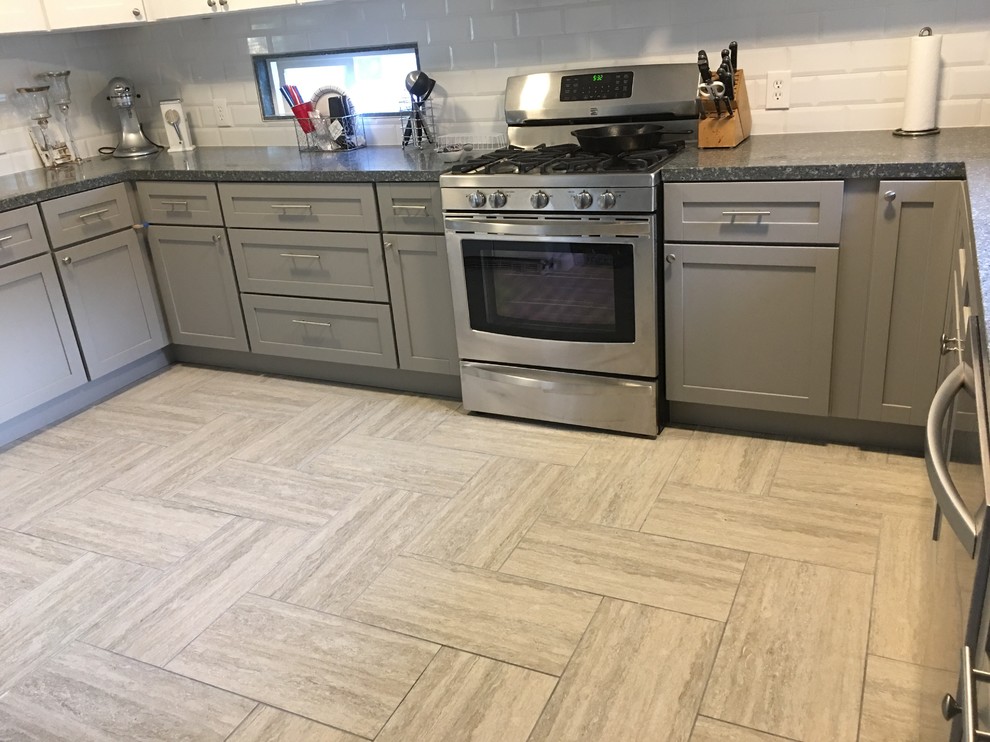 Enclosed kitchen - large transitional u-shaped beige floor enclosed kitchen idea in Orange County with shaker cabinets, gray cabinets, granite countertops, white backsplash, subway tile backsplash, stainless steel appliances and no island