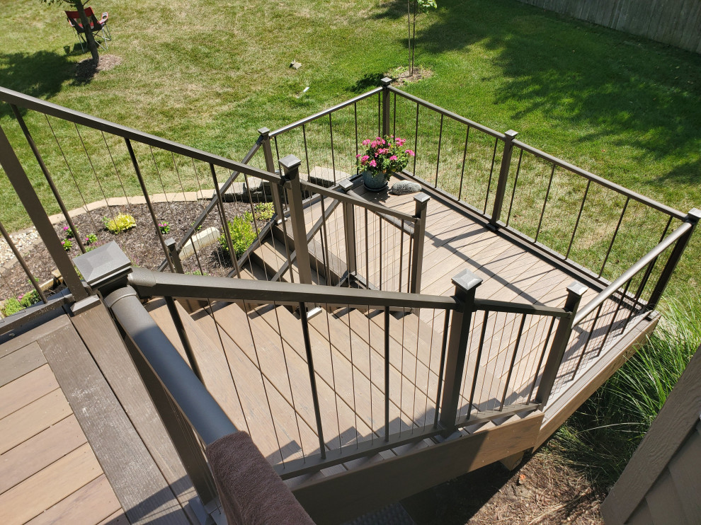 Example of a mid-sized backyard second story cable railing deck design with no cover