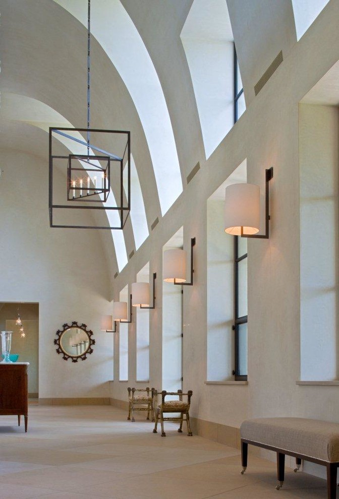 Example of a huge mountain style entry hall design in Austin with white walls
