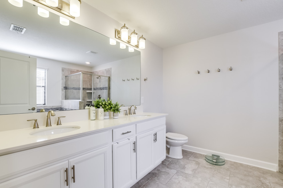 This is an example of a large contemporary master bathroom in Orlando with an undermount sink, engineered quartz benchtops, white benchtops, a double vanity and a built-in vanity.