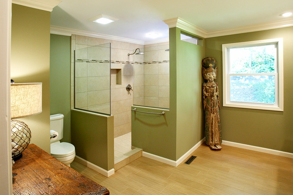 This is an example of a transitional bathroom in St Louis with a corner shower, a two-piece toilet, beige tile and ceramic tile.