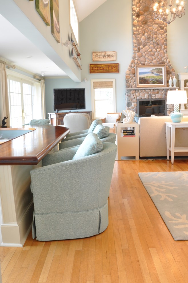 Large beach style formal open concept living room in Boston with blue walls, medium hardwood floors and no fireplace.