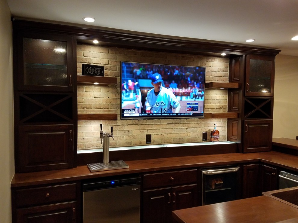 Inspiration for a transitional porcelain tile basement remodel in Columbus with beige walls, a standard fireplace and a stone fireplace