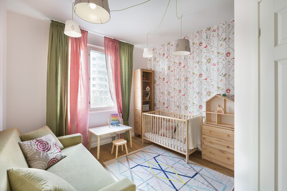 Small scandinavian nursery in Saint Petersburg with multi-coloured walls, laminate floors and beige floor for girls.