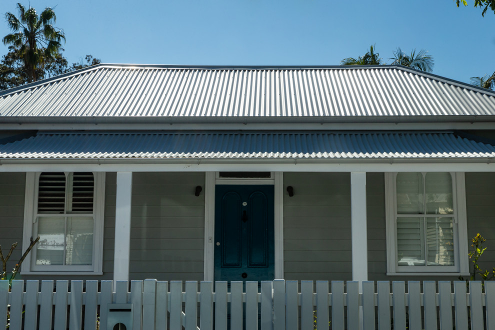 Photo of a Small traditional One-storey Grey house exterior in Sydney With a Metal Roof.