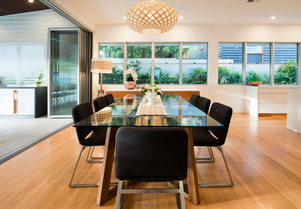 Inspiration for a contemporary open plan dining in Brisbane with light hardwood floors.