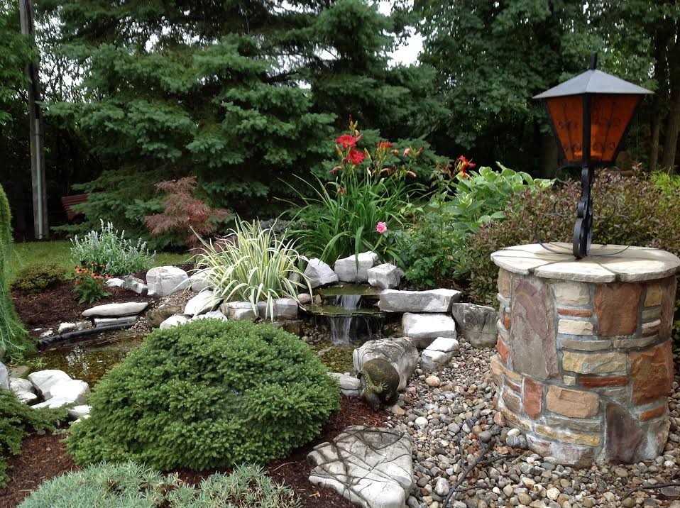 Inspiration for a large transitional front yard gravel formal garden in Ottawa.