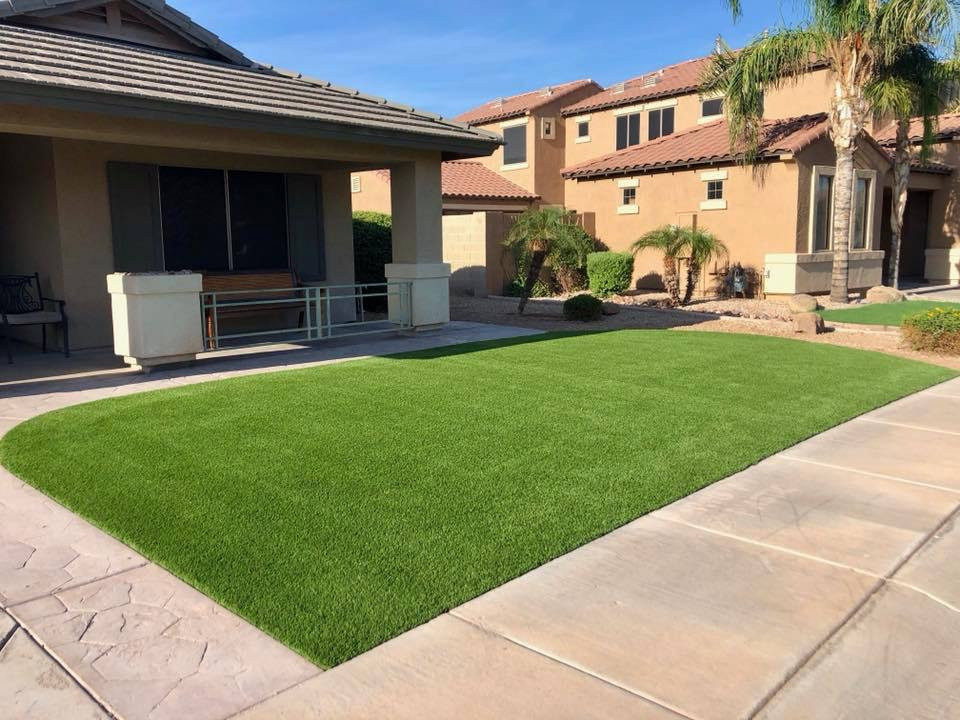 Photo of a large contemporary front yard full sun garden in Phoenix with natural stone pavers and a stone fence.