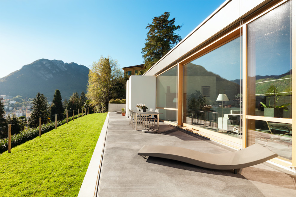 Trendy concrete patio photo with no cover