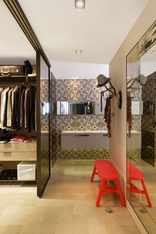 Photo of a mid-sized mediterranean gender-neutral walk-in wardrobe in Other with flat-panel cabinets, light wood cabinets and ceramic floors.