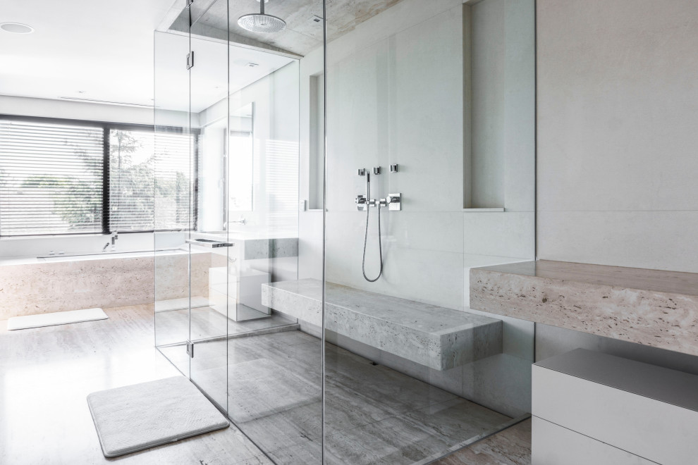 Design ideas for a large modern master bathroom in Phoenix with white cabinets, a drop-in tub, an open shower, a wall-mount toilet, gray tile, porcelain tile, grey walls, porcelain floors, a vessel sink, grey floor, a hinged shower door and vaulted.