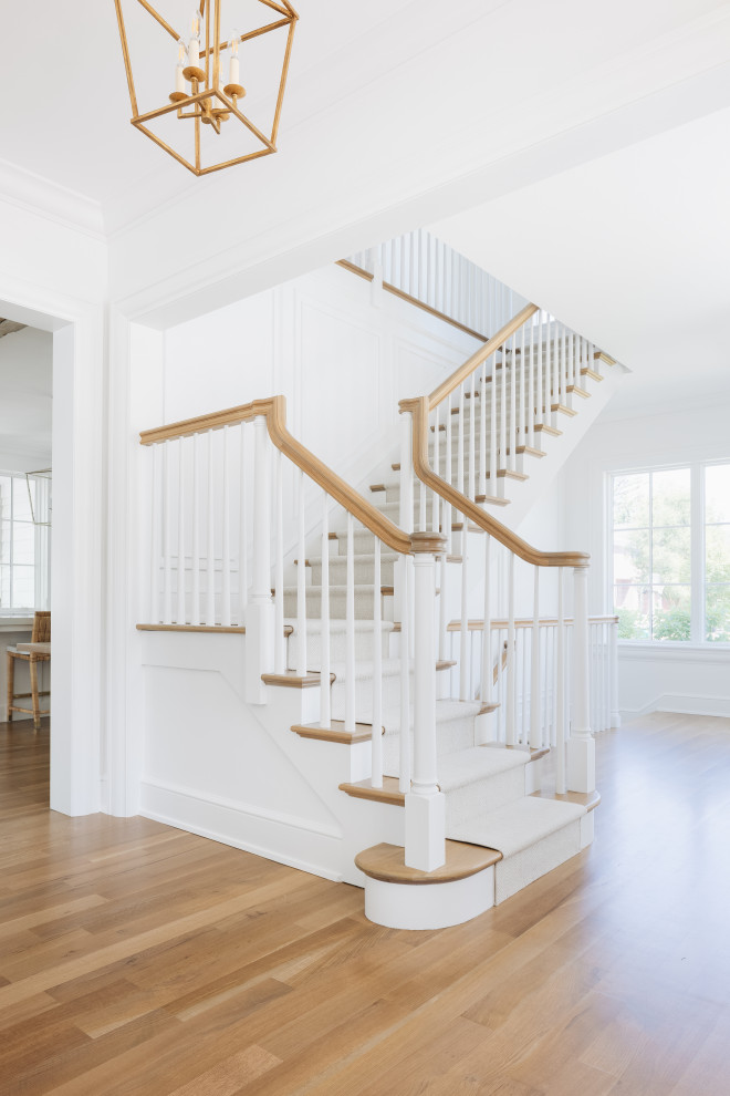 South Coast Farmhouse - Panel molding gives texture to living room, bedroom and staircase walls.
