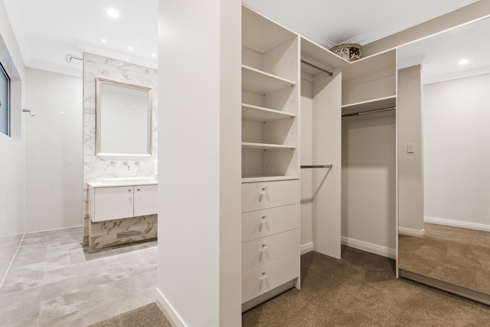 Inspiration for a beach style gender-neutral walk-in wardrobe in Perth with open cabinets, white cabinets, carpet and beige floor.
