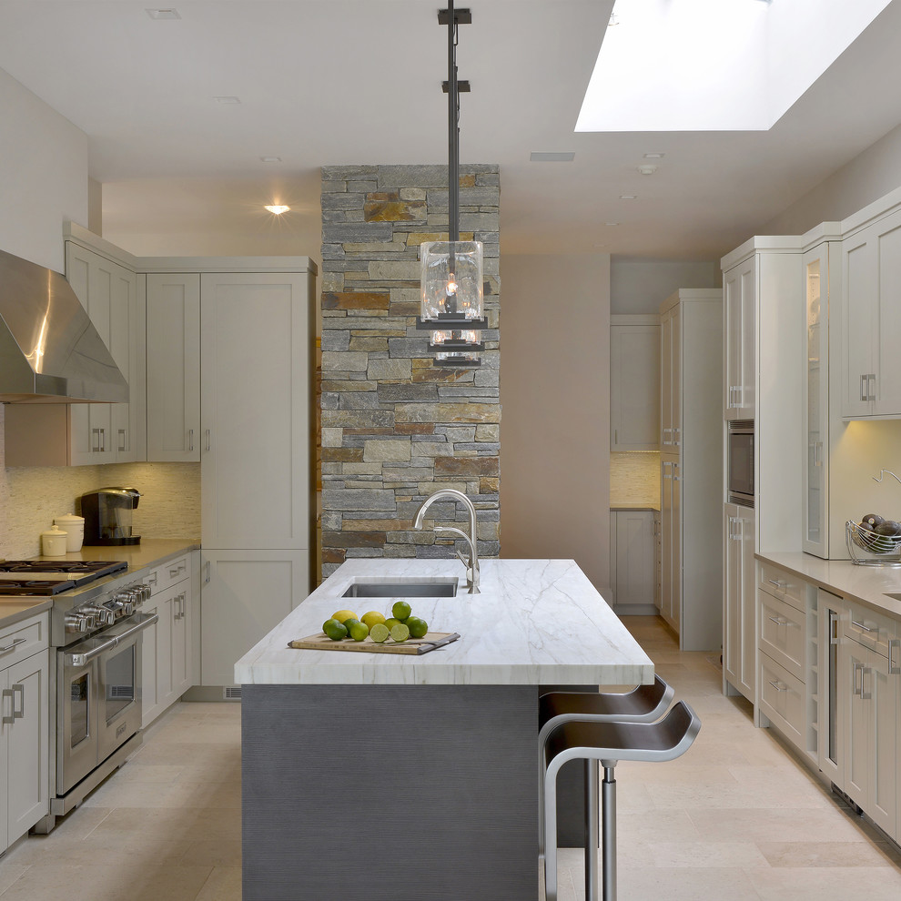 This is an example of a mid-sized contemporary galley separate kitchen in New York with an undermount sink, flat-panel cabinets, beige cabinets, beige splashback, stainless steel appliances, porcelain floors and with island.