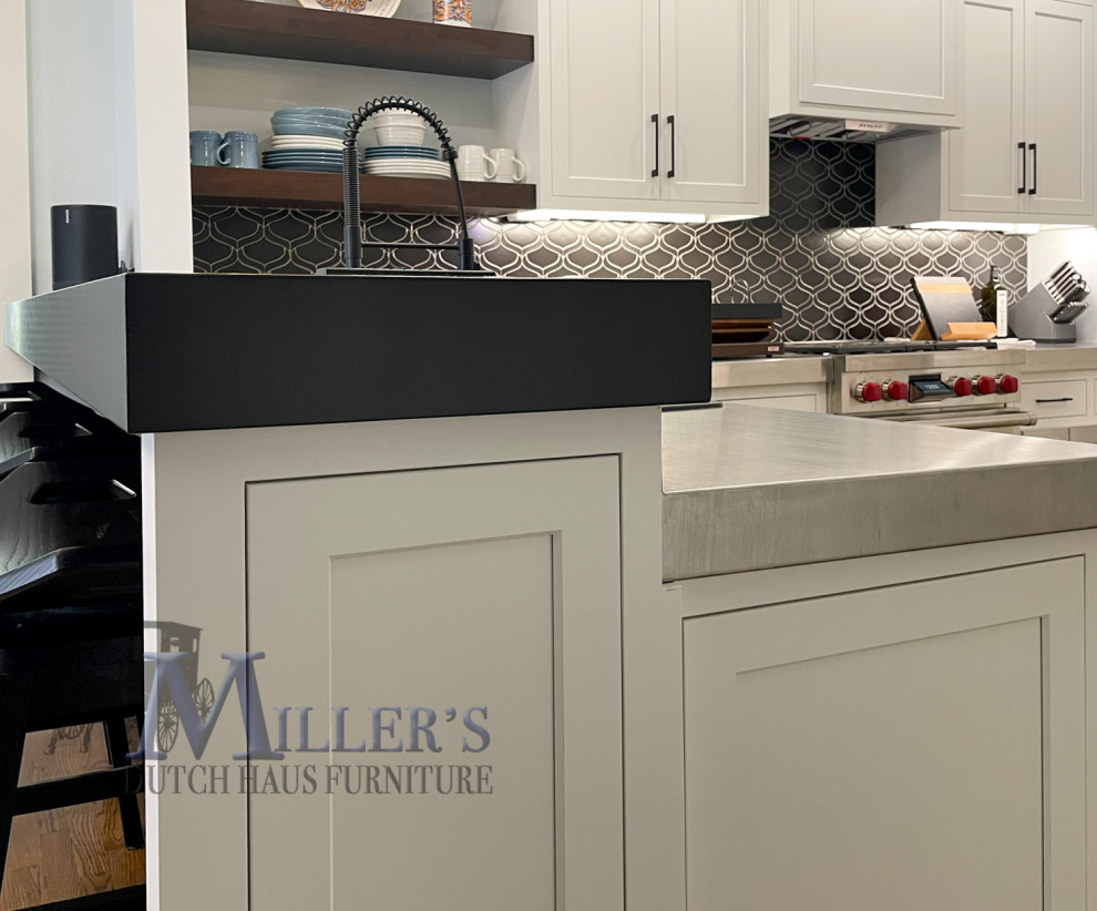 Inspiration for a large transitional u-shaped eat-in kitchen in Tampa with white cabinets, stainless steel benchtops, black splashback, black appliances, with island, brown floor and multi-coloured benchtop.