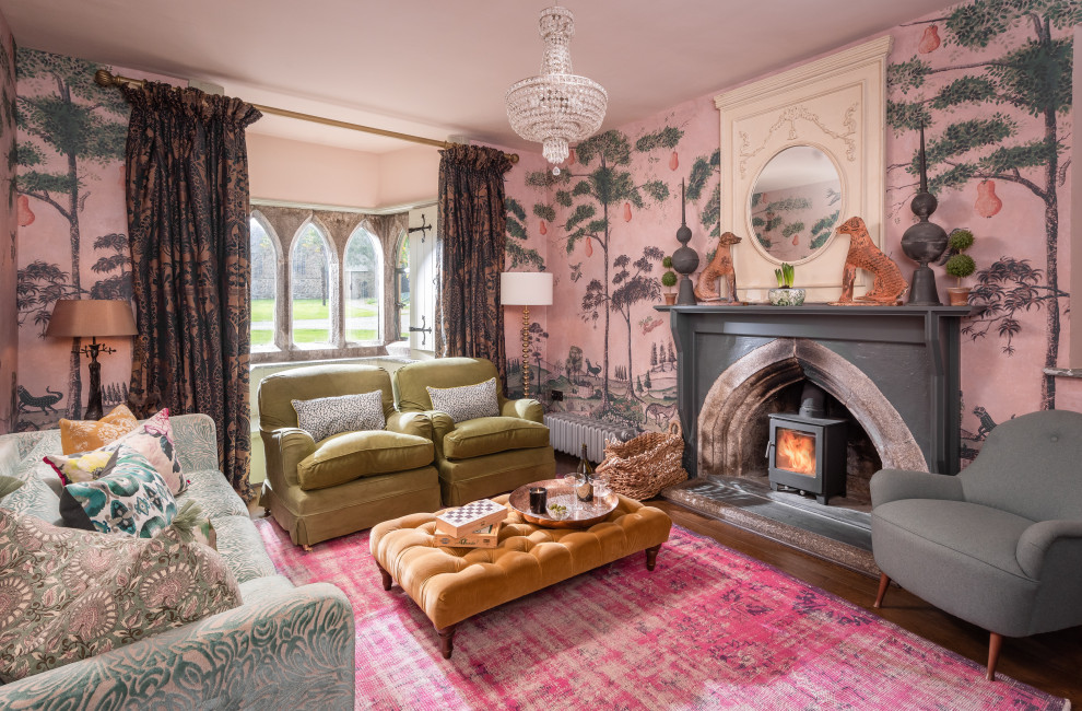 Mid-sized traditional formal enclosed living room in Cornwall with multi-coloured walls, dark hardwood floors, a standard fireplace, a stone fireplace surround and wallpaper.