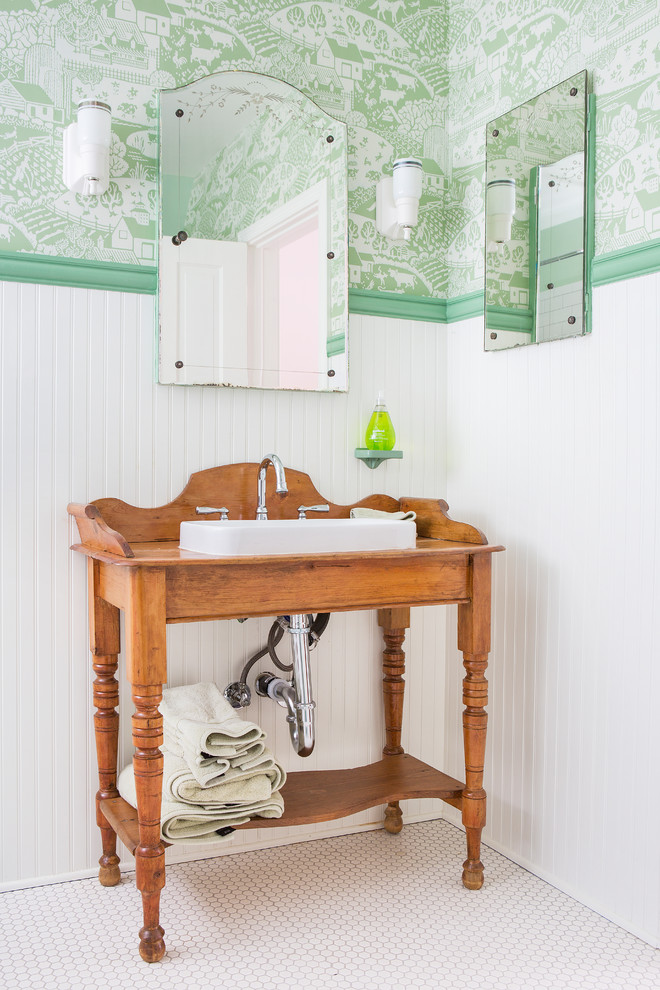 This is an example of a mid-sized country kids bathroom in Los Angeles with a drop-in sink, medium wood cabinets, green walls, mosaic tile floors, white floor, a corner tub, a shower/bathtub combo, a two-piece toilet, white tile, subway tile, a shower curtain, a niche, a single vanity, a freestanding vanity and wallpaper.