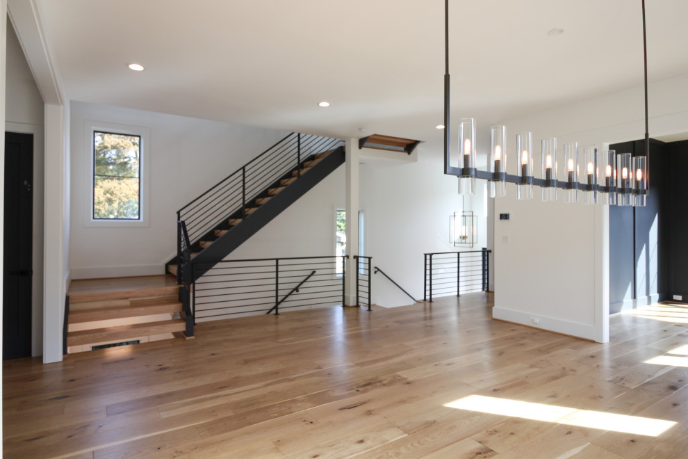 Cette image montre un escalier droit design de taille moyenne avec des marches en bois et un garde-corps en métal.